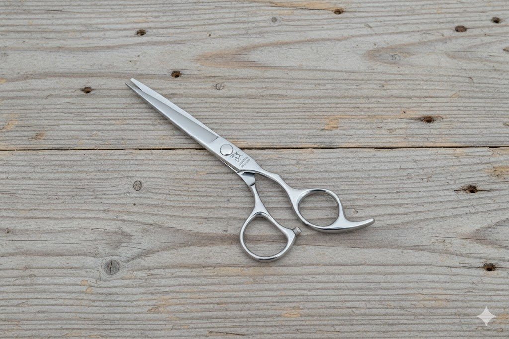 Electro Shark professional hair shears with adjustable tension screw, displayed on dark wood texture.